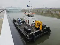 Multicat multipurpose vessel with hydraulic crane & spud pole legs